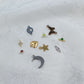 A collection of various charms featuring the Mystery Charm Box, including gold and silver designs.