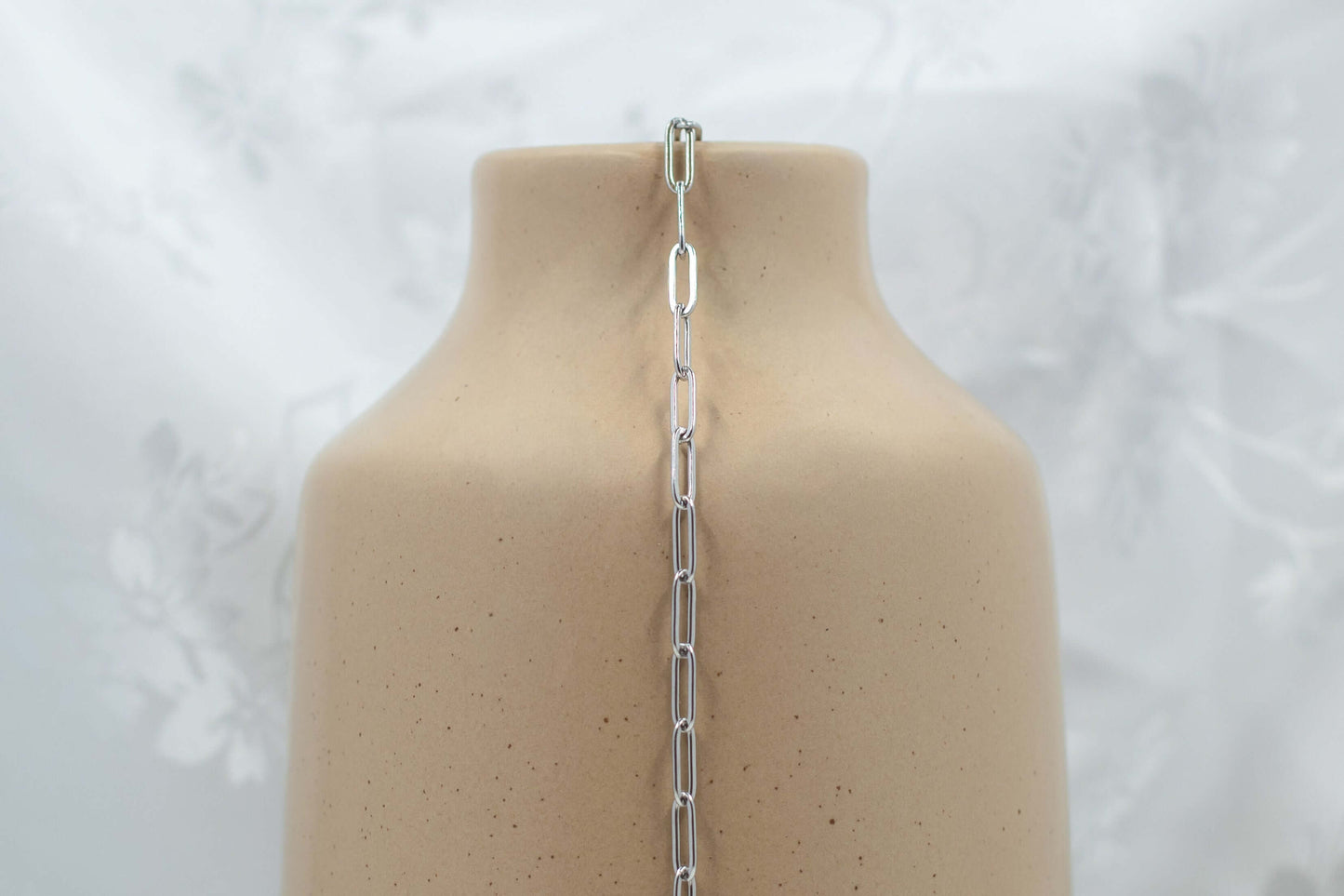 Austin chain made of 304 PVD Stainless Steel medium paperclip-style links, displayed on a vase.