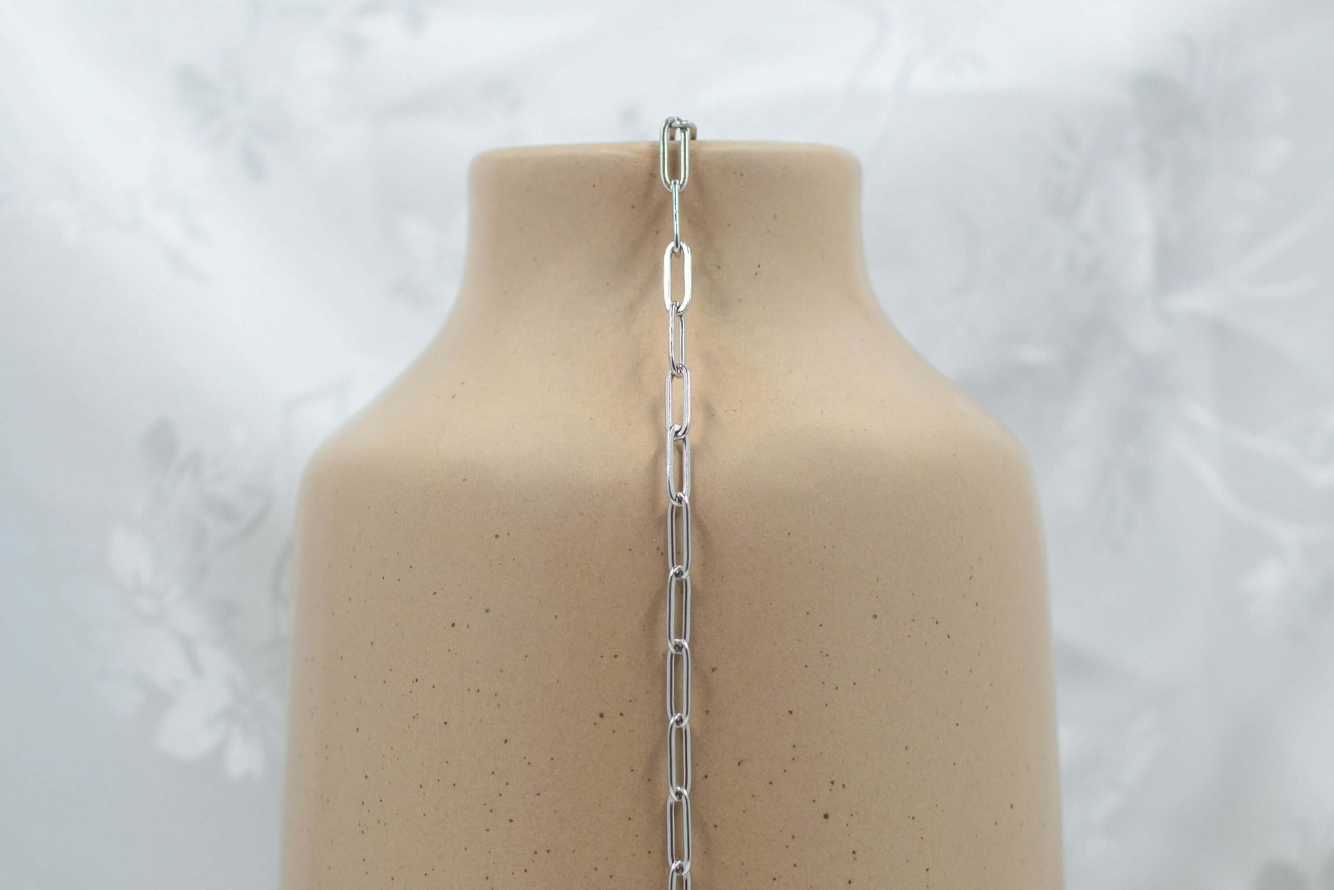 Austin chain made of 304 PVD Stainless Steel medium paperclip-style links, displayed on a vase.